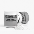 Creatine monohydrate supplement jars with scooped powder on the front