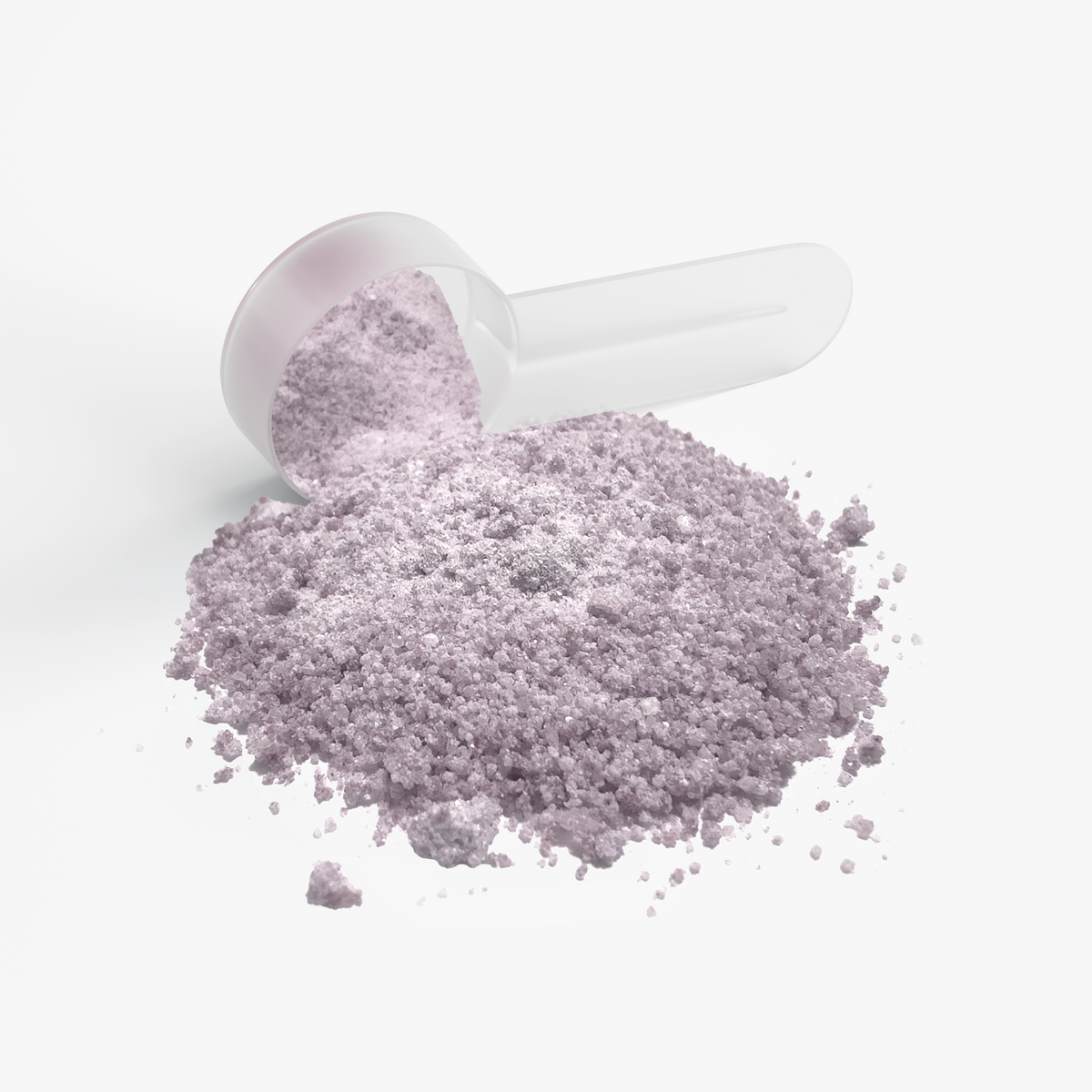 White scoop holding purple granules, with loose purple powder mound